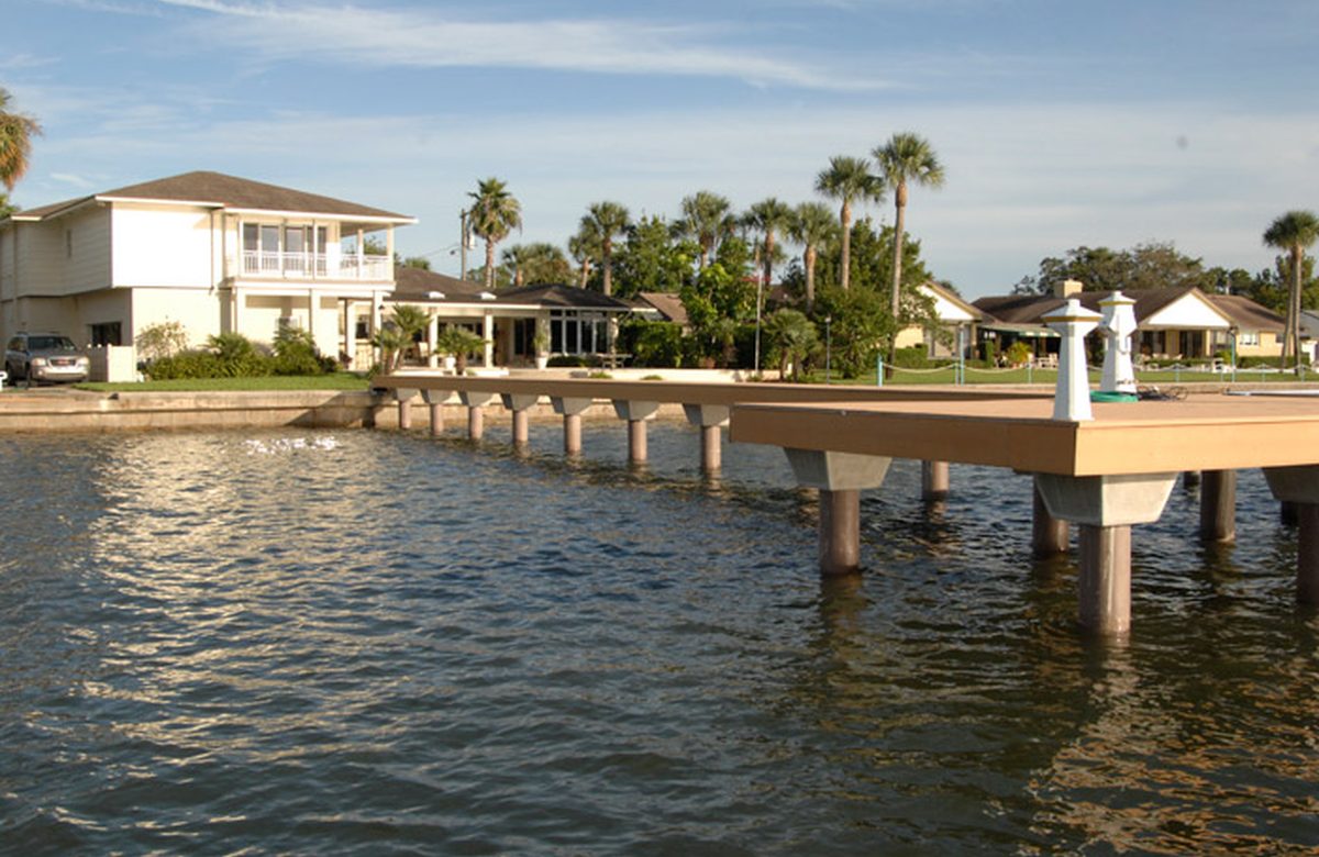 Barnacle covered dock pilings being cleaned